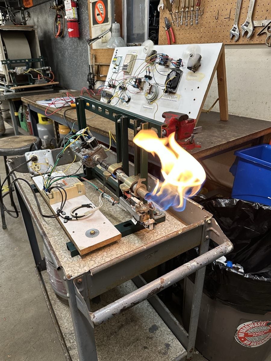 GS 102 student at an upright furnace cabinet during a fault simulation