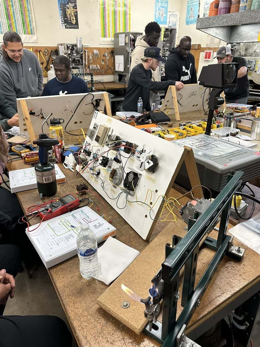 GS 102 group discussion around a diagnostic furnace bench